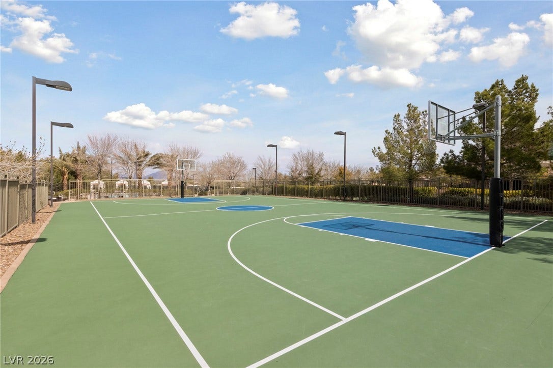 1357 Enchanted River Drive, Henderson, NV 89012 An outdoor basketball court stands ready for play beneath a bright, open sky.