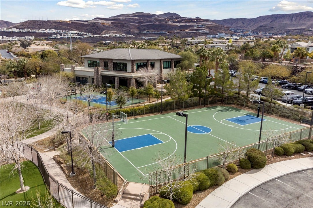 1357 Enchanted River Drive, Henderson, NV 89012 A spacious outdoor basketball court sits nestled below majestic mountain peaks.