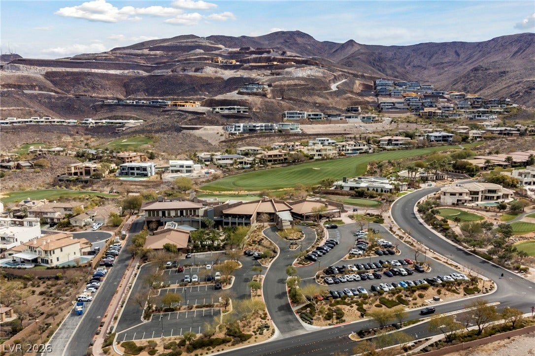 1357 Enchanted River Drive, Henderson, NV 89012 Terraced hillside homes overlook a sweeping valley golf course under a expansive desert sky.