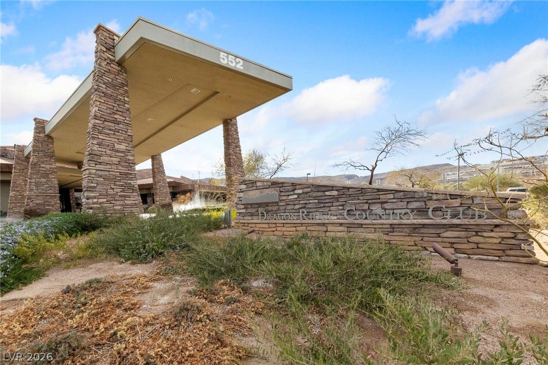 1357 Enchanted River Drive, Henderson, NV 89012 A grand stone porte-cochere marks the entrance to this exclusive desert community.