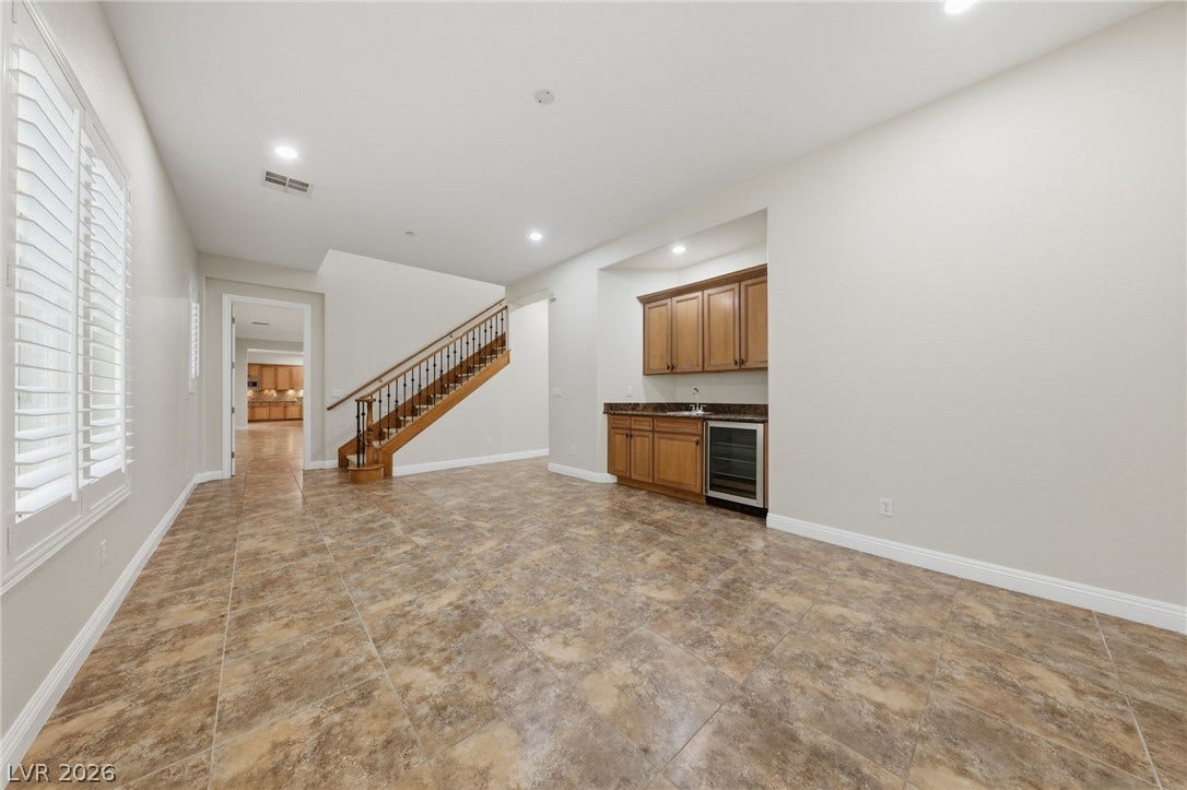 1357 Enchanted River Drive, Henderson, NV 89012 A spacious lower level features tile flooring, recessed lighting, and a convenient built-in wet bar.