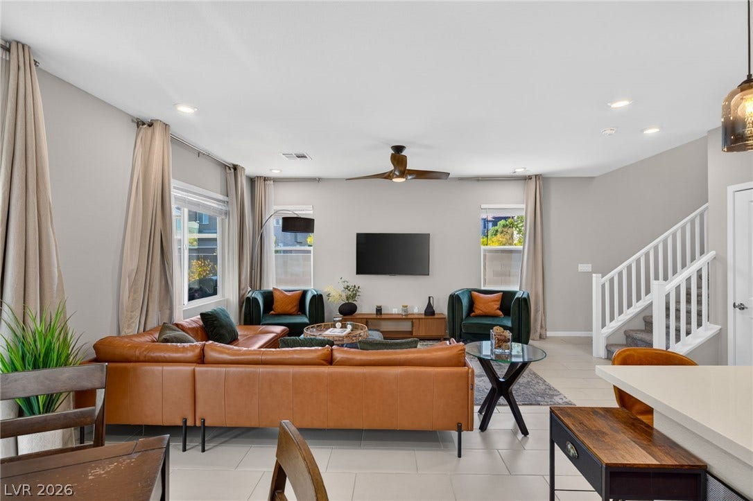 2719 High Echelon Road, North Las Vegas, NV 89086 An open living area anchors this level, offering tile flooring and natural light.