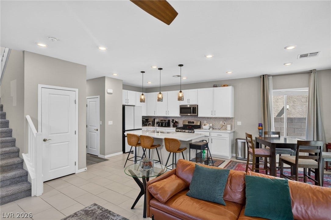 2719 High Echelon Road, North Las Vegas, NV 89086 Gleaming tile floors anchor this open-concept layout connecting the main living spaces.