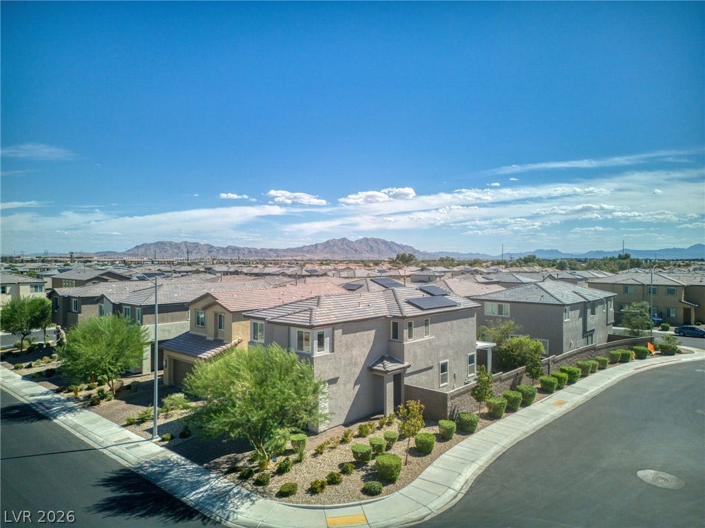 2719 High Echelon Road, North Las Vegas, NV 89086 Distant mountains frame this modern residential neighborhood under a bright desert sky.