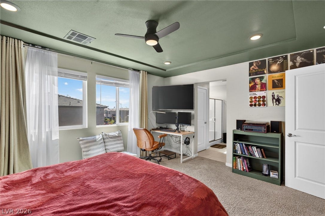 2719 High Echelon Road, North Las Vegas, NV 89086 Plentiful natural light streams across this comfortable space featuring a tray ceiling and plush carpeting.