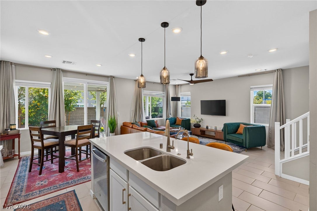 2719 High Echelon Road, North Las Vegas, NV 89086 Gleaming stone countertops and a spacious island anchor this light-filled open concept floorplan.