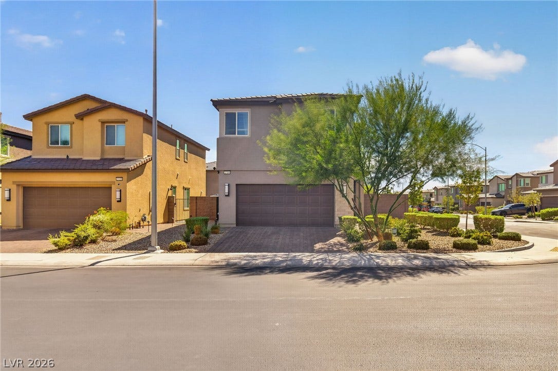 2719 High Echelon Road, North Las Vegas, NV 89086 An inviting exterior displays neat xeriscape landscaping and a paved driveway leading to a two-car garage.