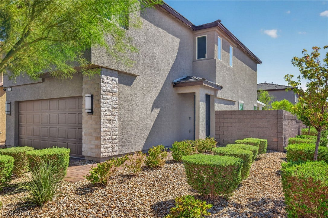 2719 High Echelon Road, North Las Vegas, NV 89086 A modern exterior featuring clean stucco lines, stone accents, and low-maintenance desert landscaping.