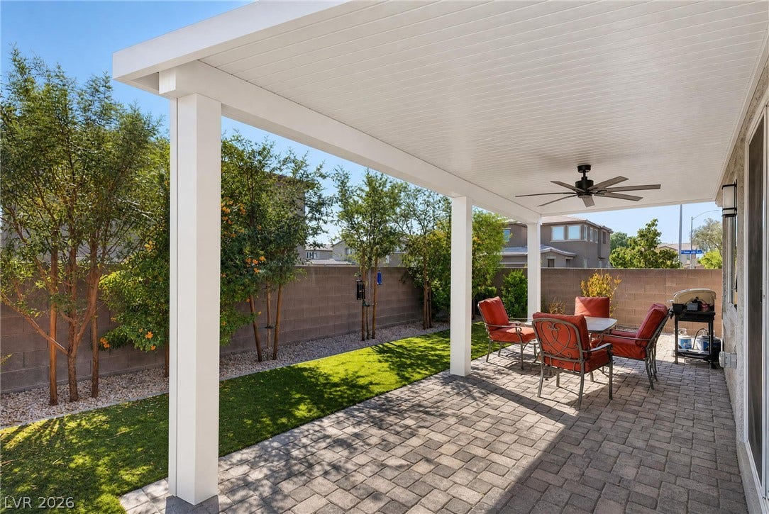 2719 High Echelon Road, North Las Vegas, NV 89086 An inviting covered patio features neat stone pavers alongside a landscaped, private backyard.