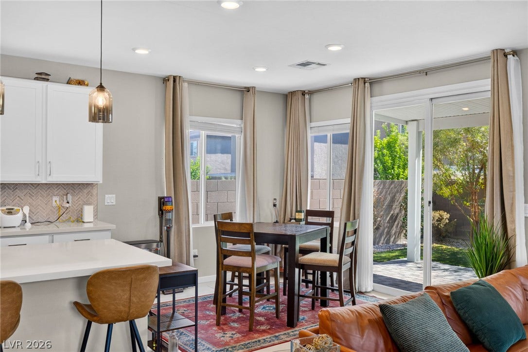 2719 High Echelon Road, North Las Vegas, NV 89086 Sliding glass doors open from the dining area to a private covered patio.