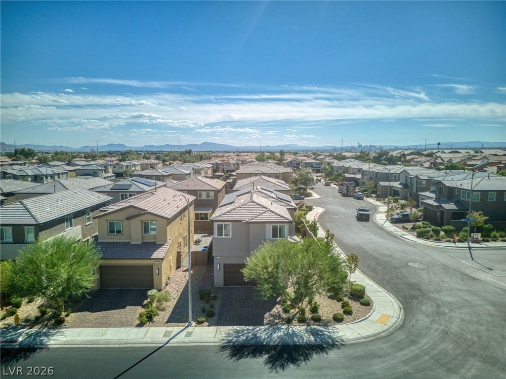 2719 High Echelon Road, North Las Vegas, NV 89086 An aerial perspective reveals a charming suburban neighborhood under a bright blue sky.