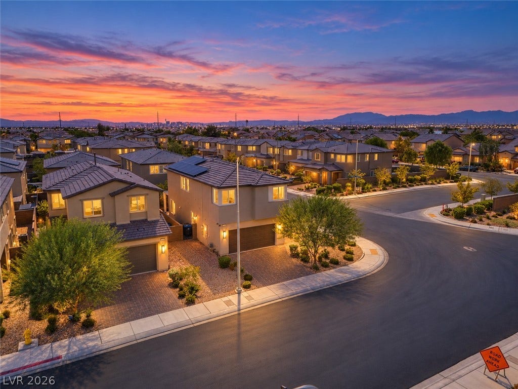 2719 High Echelon Road, North Las Vegas, NV 89086 Dusk skies frame a quiet neighborhood of two-story homes with tile roofs.