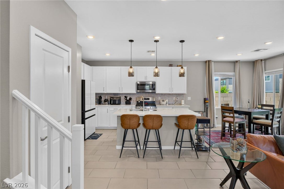 2719 High Echelon Road, North Las Vegas, NV 89086 Gleaming tile floors and a massive center island define this bright, open kitchen.