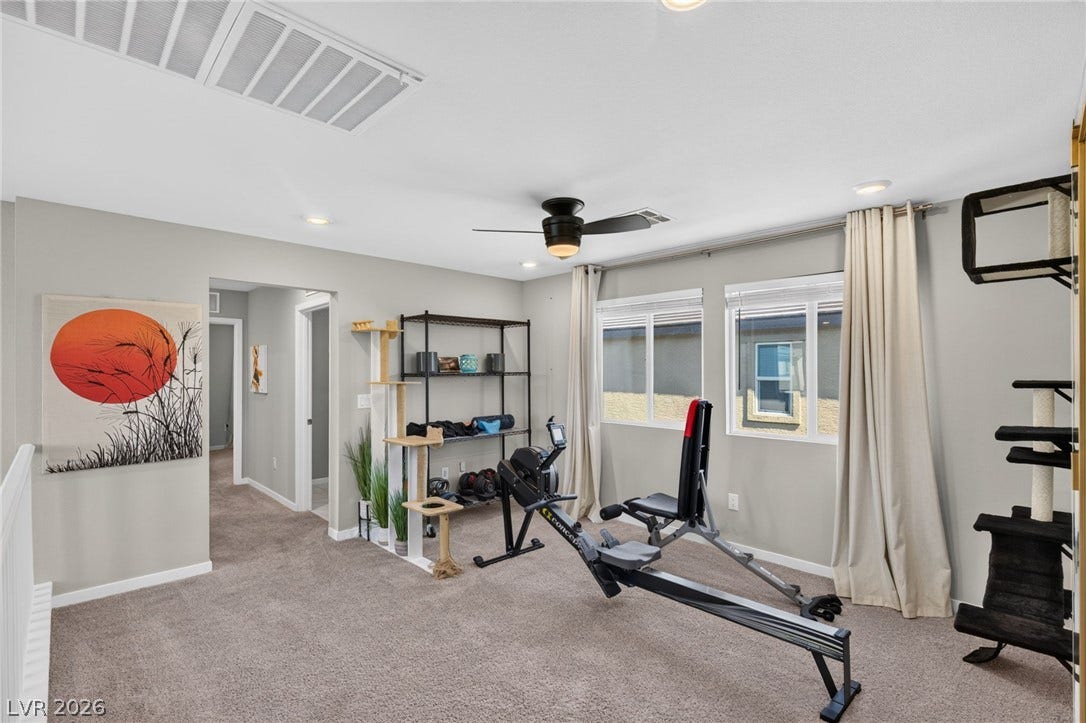 2719 High Echelon Road, North Las Vegas, NV 89086 An open upstairs loft features wall-to-wall carpeting and recessed lighting.