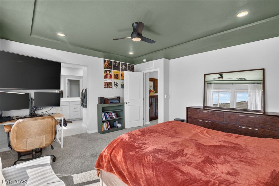 2719 High Echelon Road, North Las Vegas, NV 89086 A tray ceiling pairs with soft carpeting in this comfortable primary bedroom suite.
