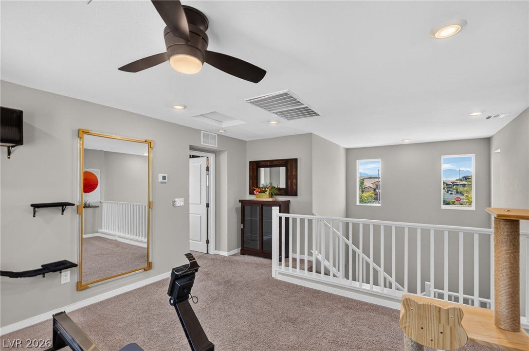 2719 High Echelon Road, North Las Vegas, NV 89086 An open loft space features plush carpeting, recessed lighting, and a view of the staircase.
