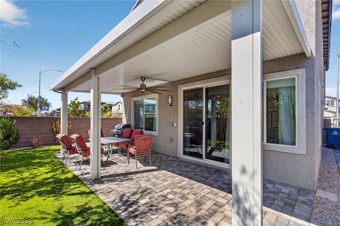2719 High Echelon Road, North Las Vegas, NV 89086 An inviting covered paver patio overlooks a manicured green lawn.
