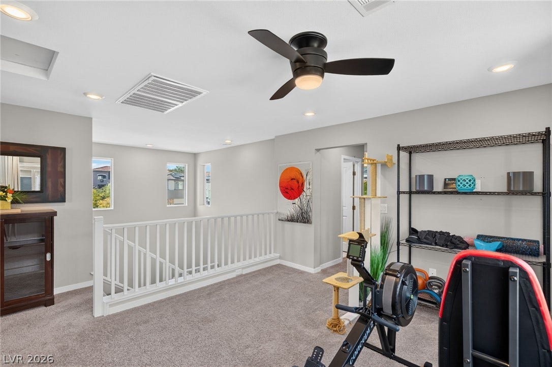 2719 High Echelon Road, North Las Vegas, NV 89086 Plush carpeting anchors this versatile upper level space overlooking the staircase.