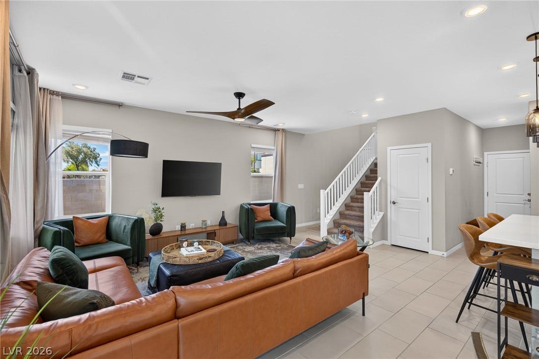 2719 High Echelon Road, North Las Vegas, NV 89086 Recessed lighting and tile floors define this open living area connected to a central staircase.