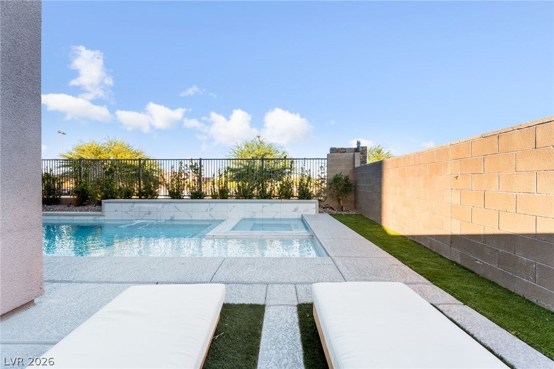 12424 Point Sierra Street, Las Vegas, NV 89138 A sparkling swimming pool and adjacent spa are framed by a clean concrete patio and privacy walls.