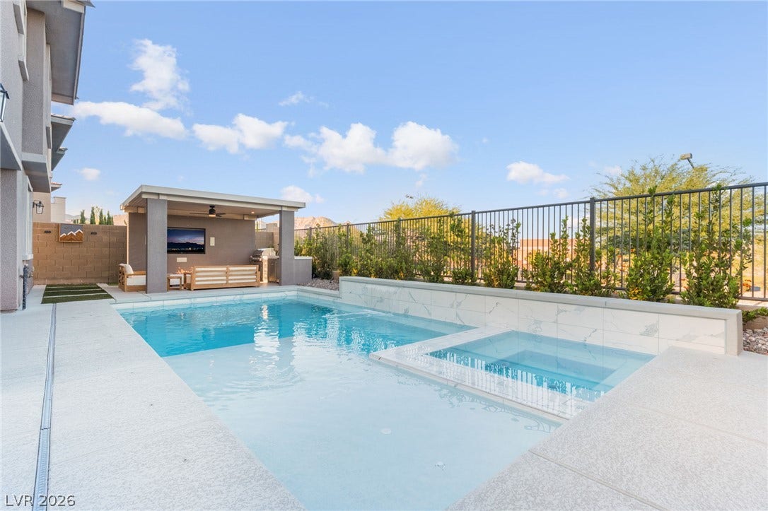 12424 Point Sierra Street, Las Vegas, NV 89138 An inviting backyard oasis features a clean-lined swimming pool with an integrated spa.