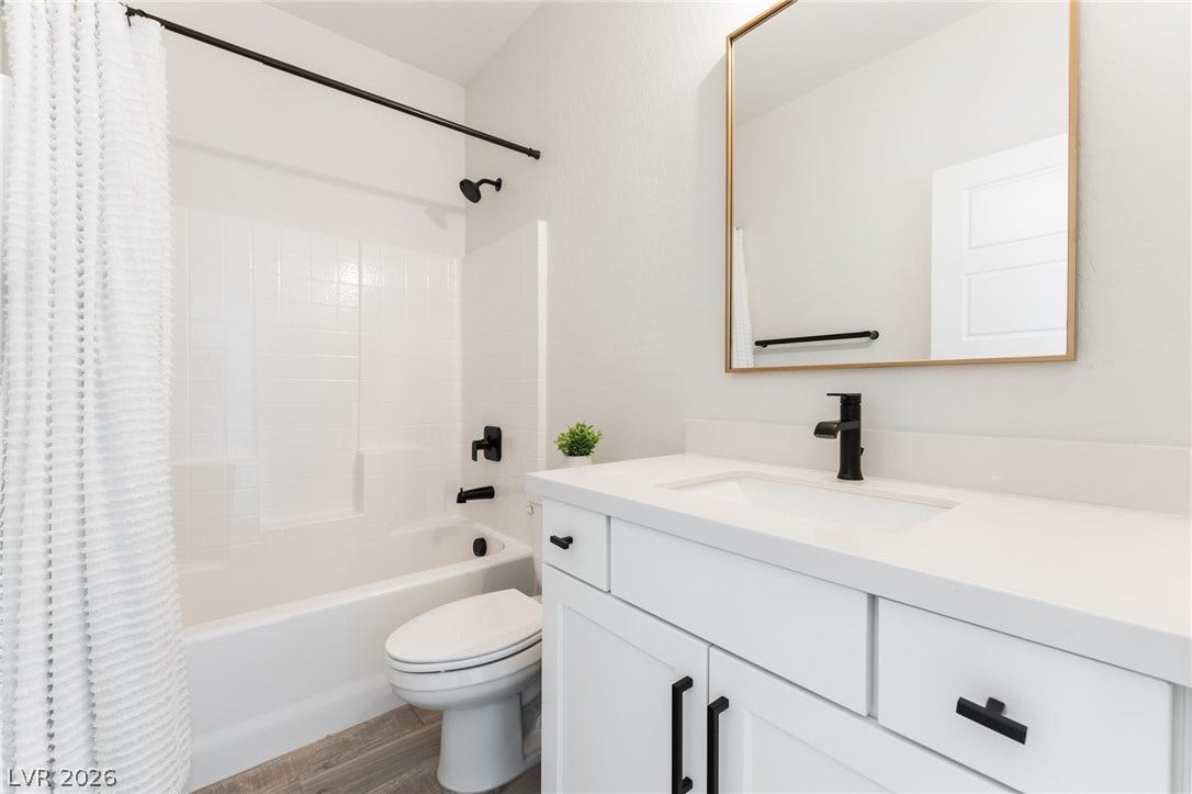 12424 Point Sierra Street, Las Vegas, NV 89138 Clean lines and modern dark hardware define this updated washroom space.