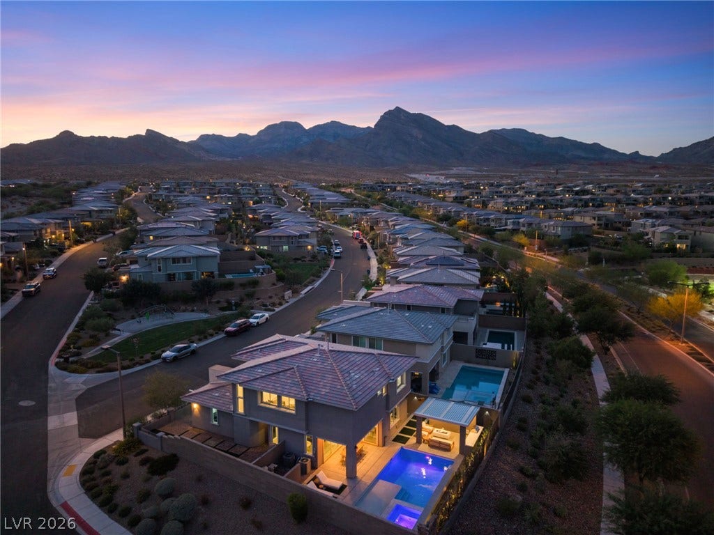 12424 Point Sierra Street, Las Vegas, NV 89138 Dramatic mountain backdrops frame this modern neighborhood at twilight.