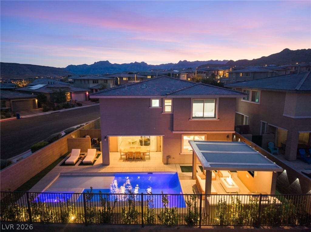 12424 Point Sierra Street, Las Vegas, NV 89138 Dramatic mountain backdrops frame a multi-level modern design featuring a private pool and integrated pergola.