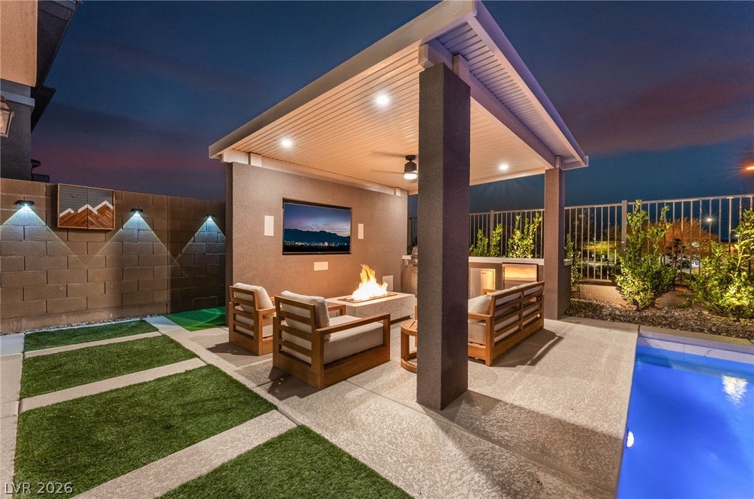 12424 Point Sierra Street, Las Vegas, NV 89138 An inviting covered patio sits adjacent to a pristine pool under the evening sky.