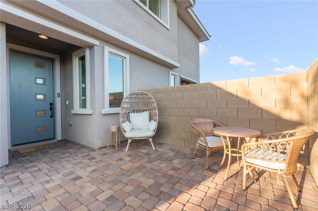 12424 Point Sierra Street, Las Vegas, NV 89138 A private paved courtyard provides a welcoming entry sequence framed by block fencing.