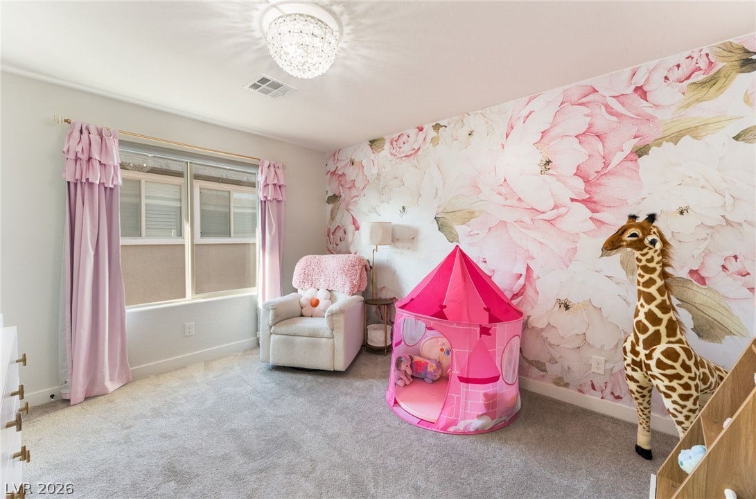 12424 Point Sierra Street, Las Vegas, NV 89138 Soft carpet flooring underfoot and a large window anchor this charming bedroom space.