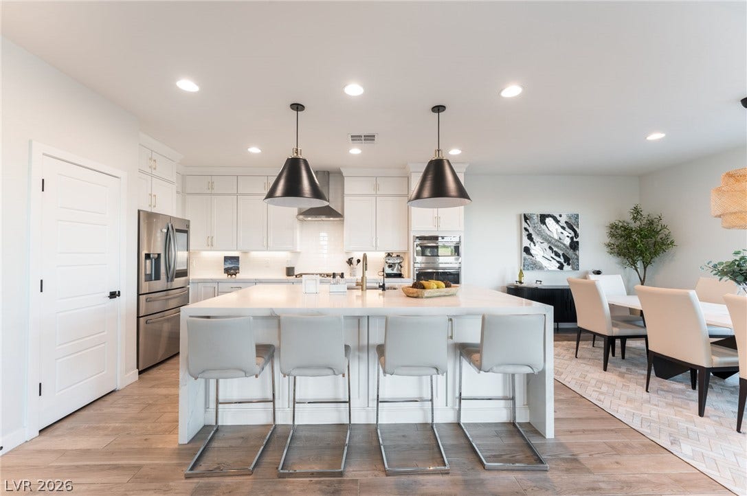 12424 Point Sierra Street, Las Vegas, NV 89138 Gleaming hardwood floors and a spacious center island anchor this open-concept kitchen.