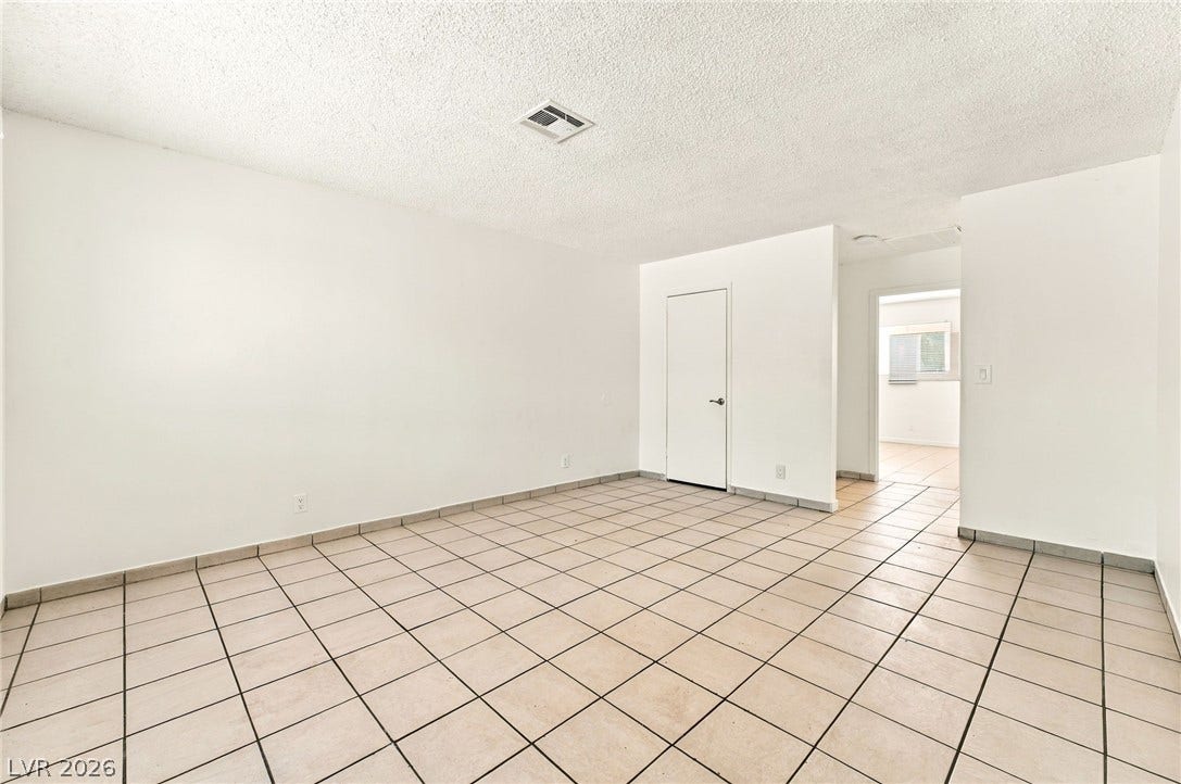 2553 Ellis Street, North Las Vegas, NV 89030 Tiled flooring and neutral walls define this versatile living space.