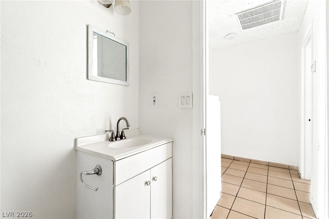 2553 Ellis Street, North Las Vegas, NV 89030 Clean lines and tiled flooring define this functional powder room space.