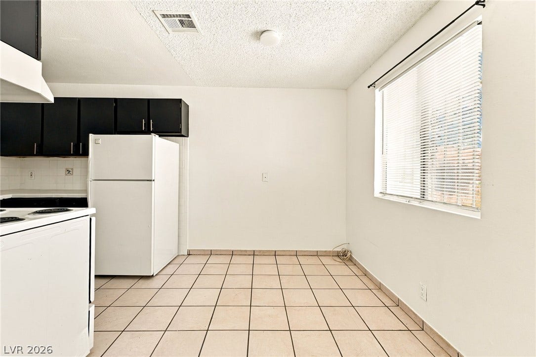 2553 Ellis Street, North Las Vegas, NV 89030 Tiled flooring and a bright window highlight this functional kitchen eating area.
