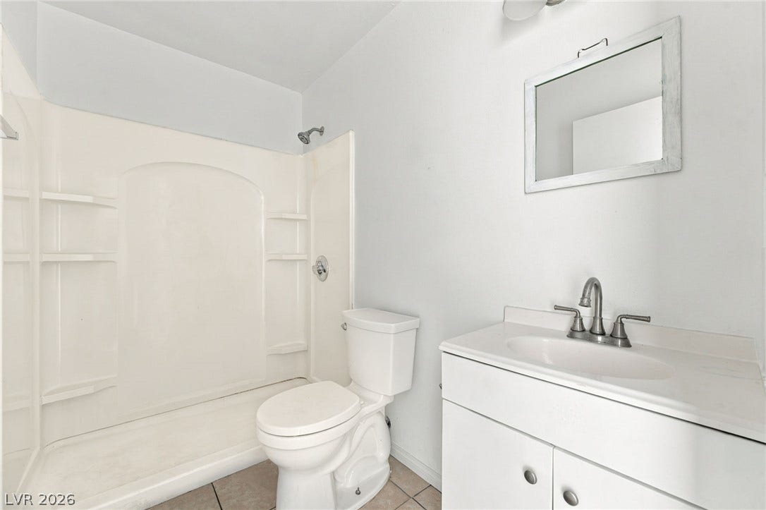 2553 Ellis Street, North Las Vegas, NV 89030 A clean vanity and a walk-in shower surround define this functional bathroom space.