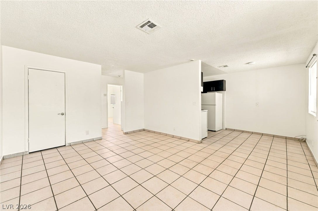 2553 Ellis Street, North Las Vegas, NV 89030 Tiled floors and clean white walls anchor this versatile open-concept living area.