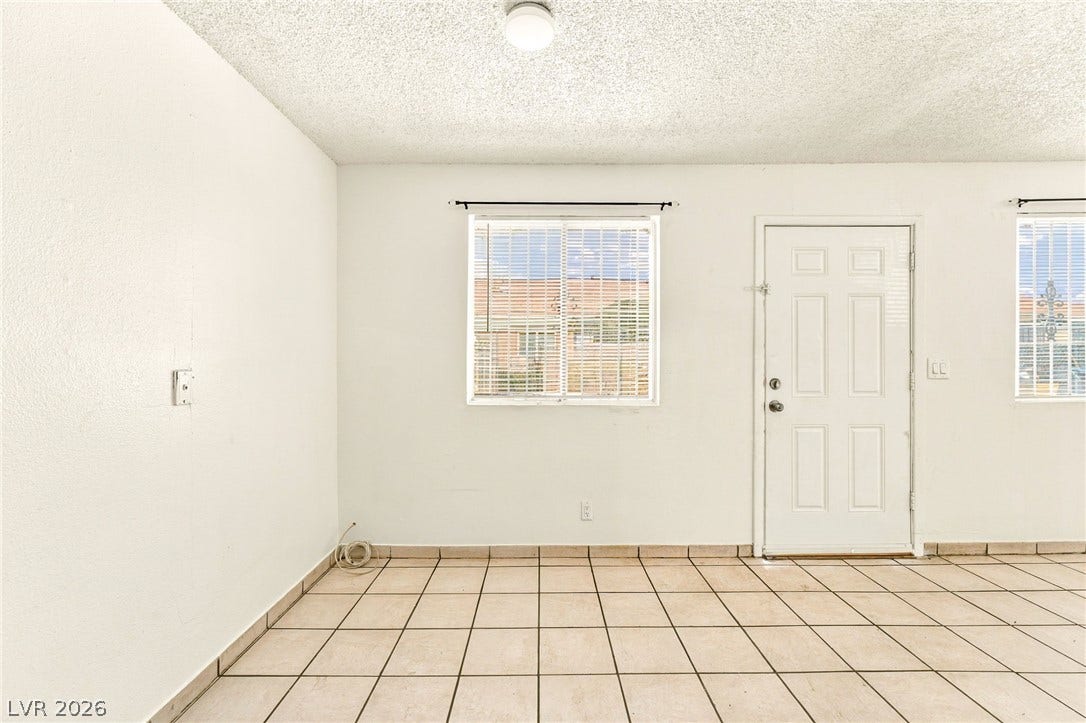 2553 Ellis Street, North Las Vegas, NV 89030 Durable tile flooring anchors this versatile living space filled with natural light.