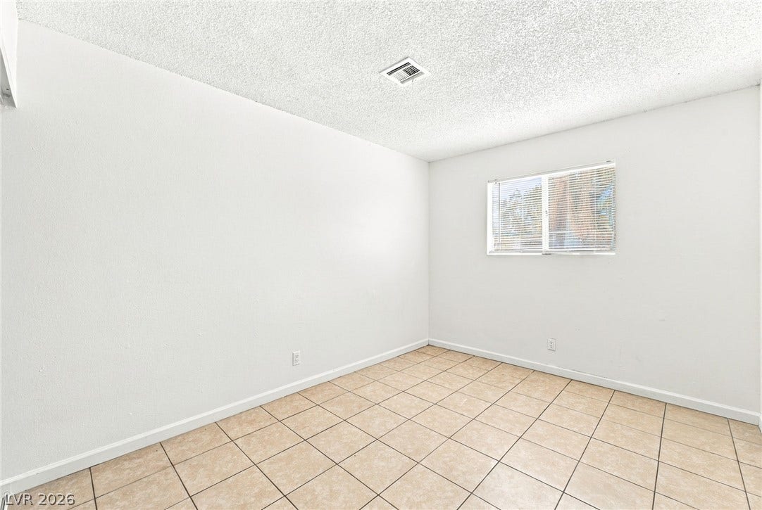 2553 Ellis Street, North Las Vegas, NV 89030 Tiled flooring and simple wall finishes define this versatile secondary room.