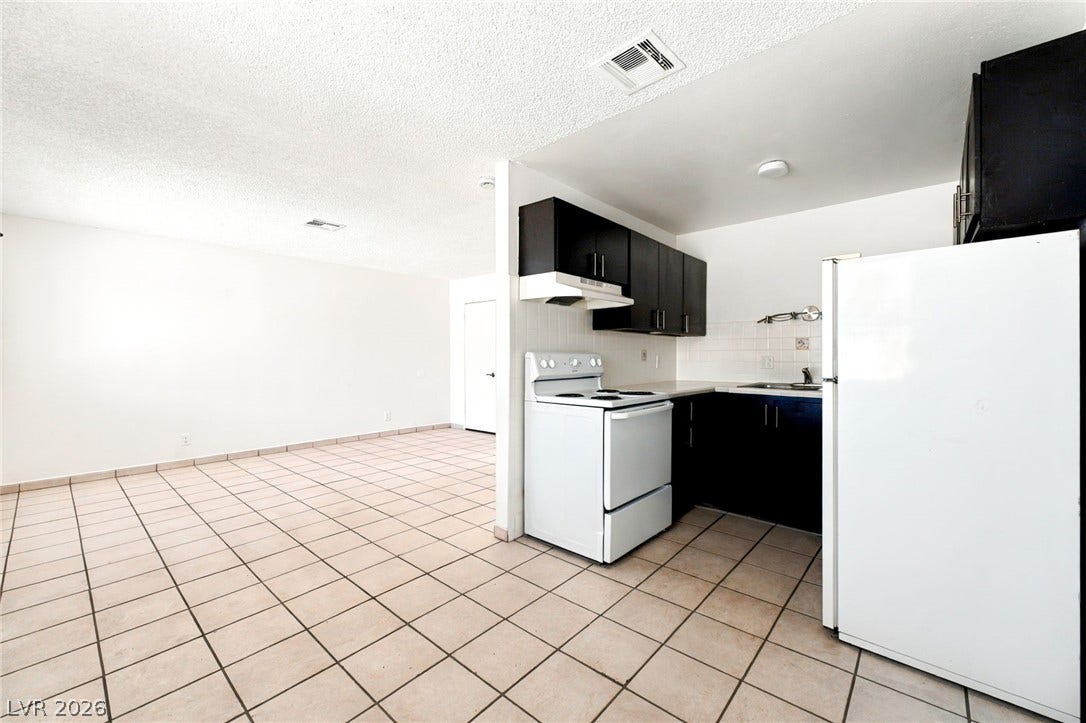 2553 Ellis Street, North Las Vegas, NV 89030 An open kitchen connects seamlessly to a versatile dining area with durable tile flooring.