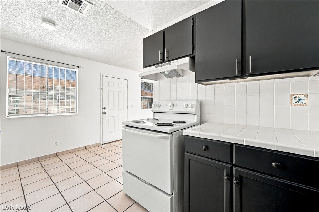 2553 Ellis Street, North Las Vegas, NV 89030 Practical tile floors and contrasting dark cabinetry define this functional culinary space.