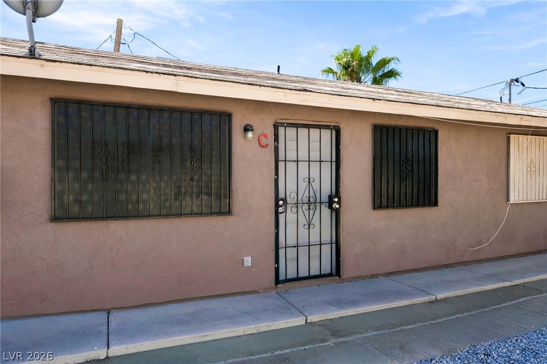 2553 Ellis Street, North Las Vegas, NV 89030 Stucco exterior walls and a concrete walkway frame the front entry of this residence.