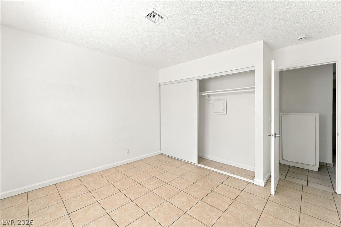 2553 Ellis Street, North Las Vegas, NV 89030 Tiled floors and a wide closet define this minimalist secondary bedroom space.