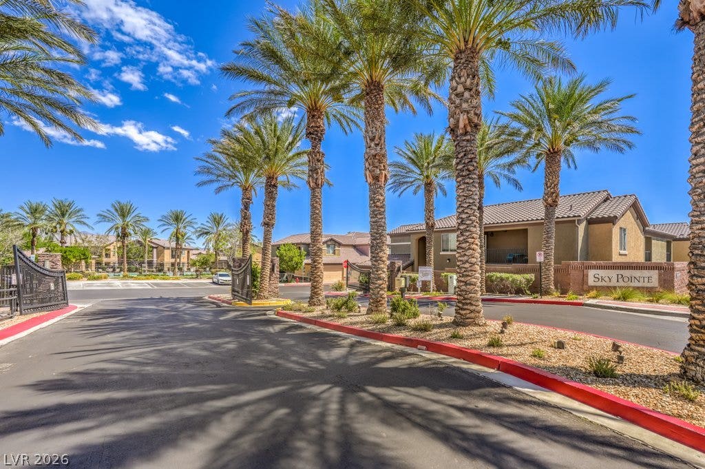 6868 Sky Pointe Drive, #1132, Las Vegas, NV 89131 Palm trees frame the secure gated entry leading into this manicured community.