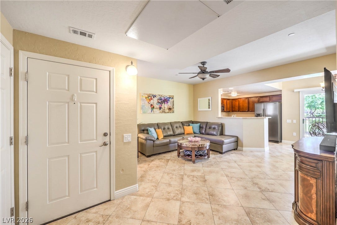 6868 Sky Pointe Drive, #1132, Las Vegas, NV 89131 Tiled flooring and a neutral color palette welcome visitors into this open living space.