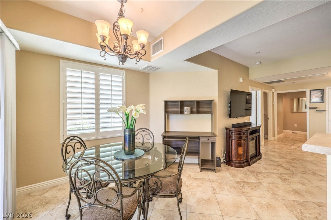 6868 Sky Pointe Drive, #1132, Las Vegas, NV 89131 Tile flooring and built-in architectural details define this welcoming open-concept dining space.