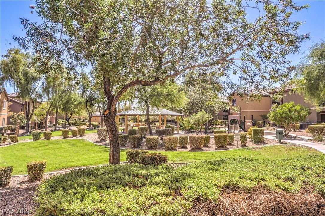 6868 Sky Pointe Drive, #1132, Las Vegas, NV 89131 Mature trees and neat green lawns border a quiet common area featuring a shaded gazebo.