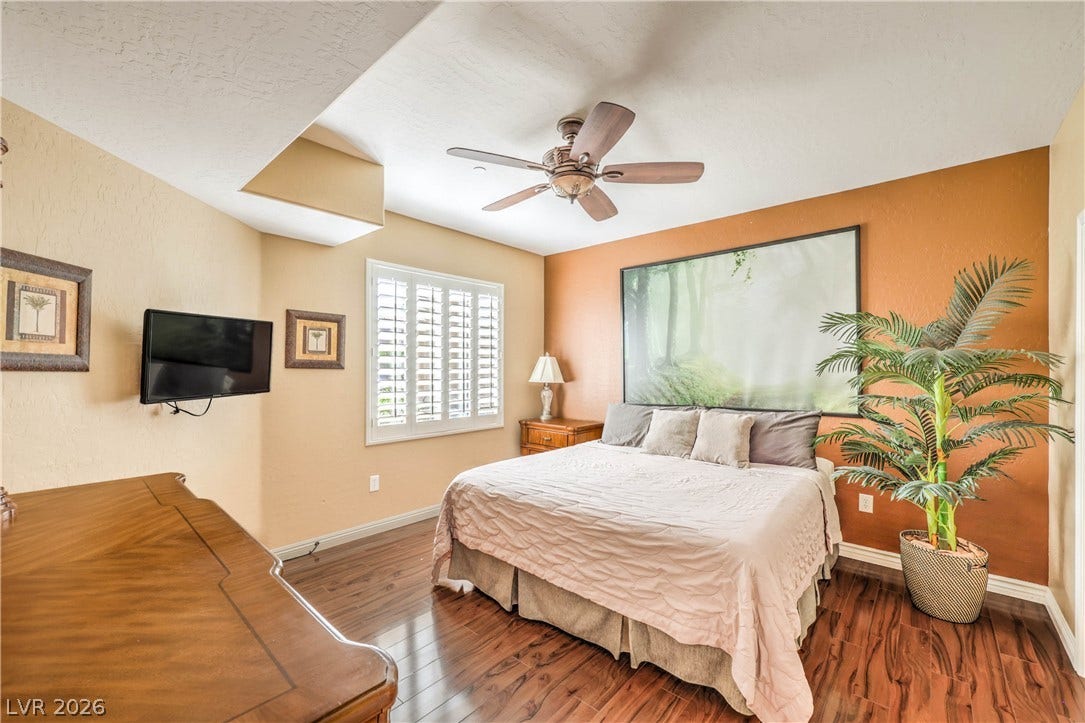6868 Sky Pointe Drive, #1132, Las Vegas, NV 89131 Gleaming hardwood floors run throughout this comfortable bedroom boasting warm textured walls.