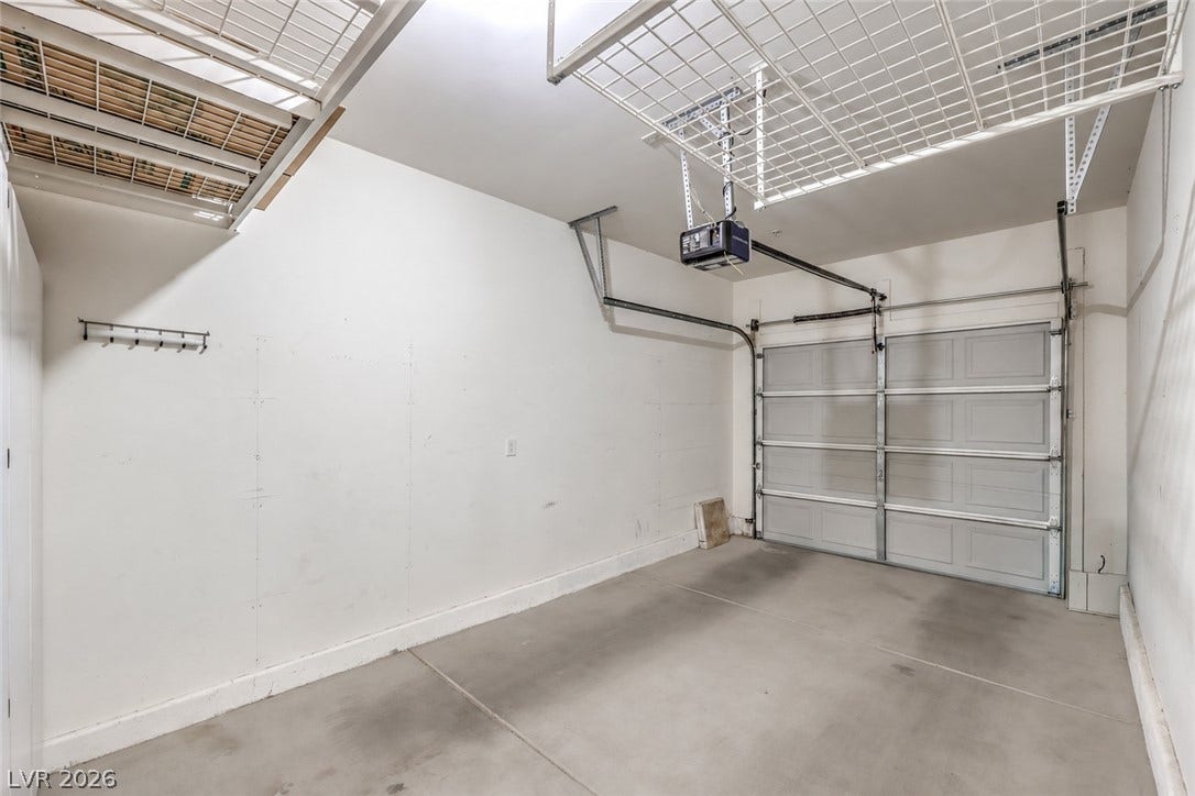 6868 Sky Pointe Drive, #1132, Las Vegas, NV 89131 An organized garage space incorporates durable concrete flooring and integrated overhead storage racks.