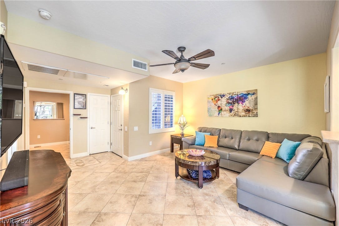 6868 Sky Pointe Drive, #1132, Las Vegas, NV 89131 Tiled flooring and natural light from shutters enhance this comfortable living space.